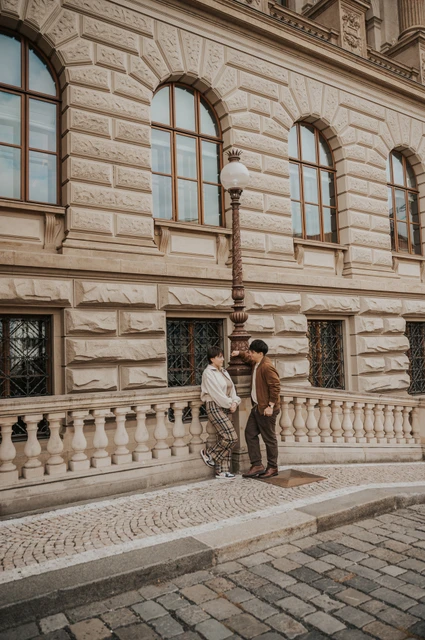 Prague couple photoshoot: couple standing close against the museum facade. Couple standing close against the museum facade during a couple photoshoot in Prague.