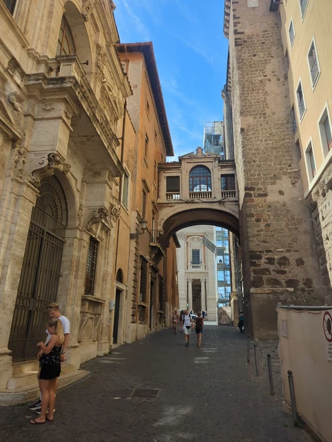 Arched Passage near the Campidoglio An enclosed stone bridge spans a narrow lane between historic buildings near the Campidoglio in Rome.