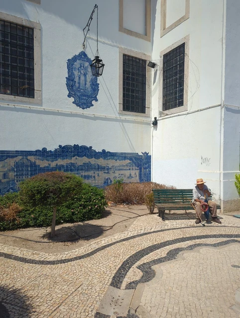 Blue-and-white azulejos beside a green bench at Santa Luzia in Lisbon