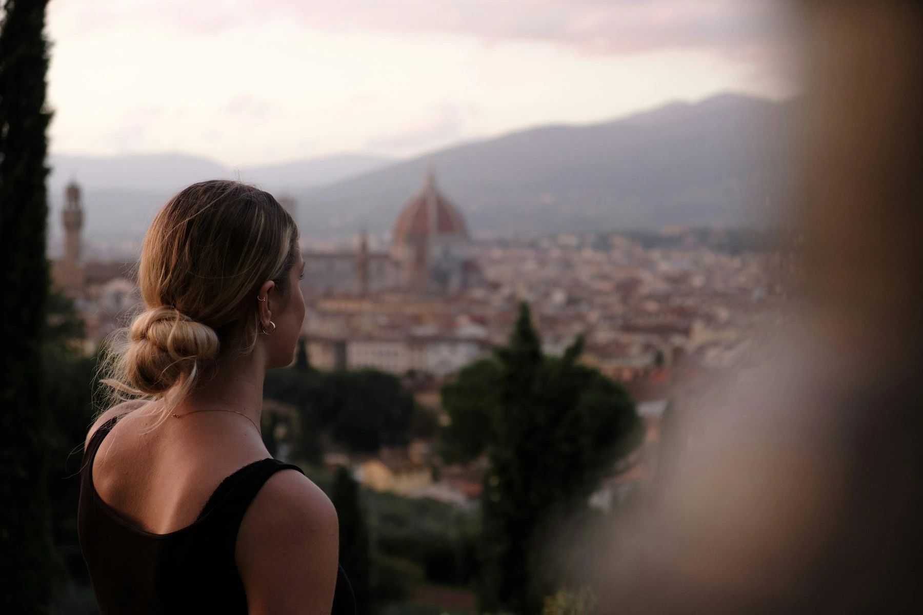 Woman looking across the Florence skyline with the cathedral dome in the distance