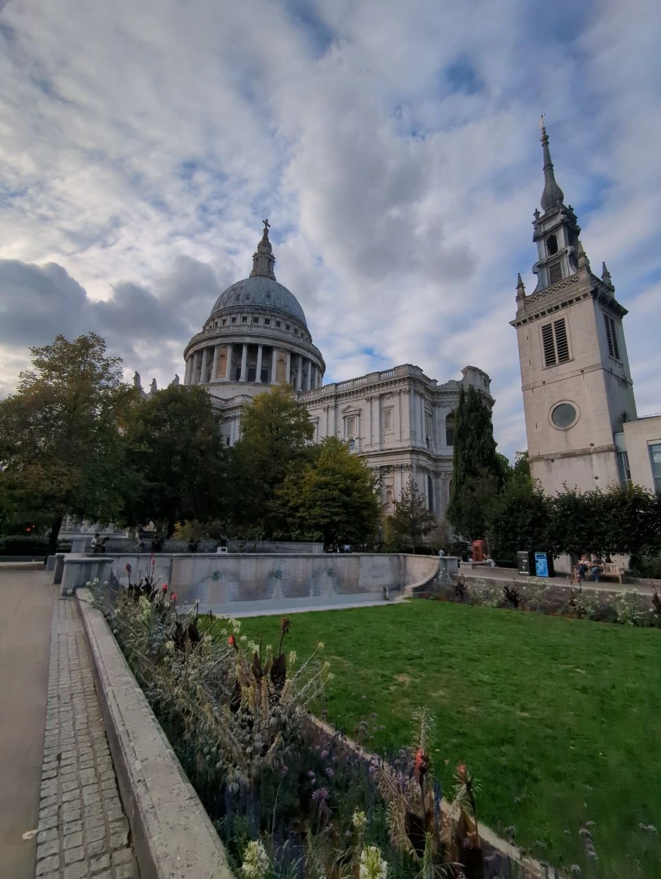 Lawn and planted beds below a stone terrace with St Paul’s Cathedral beyond