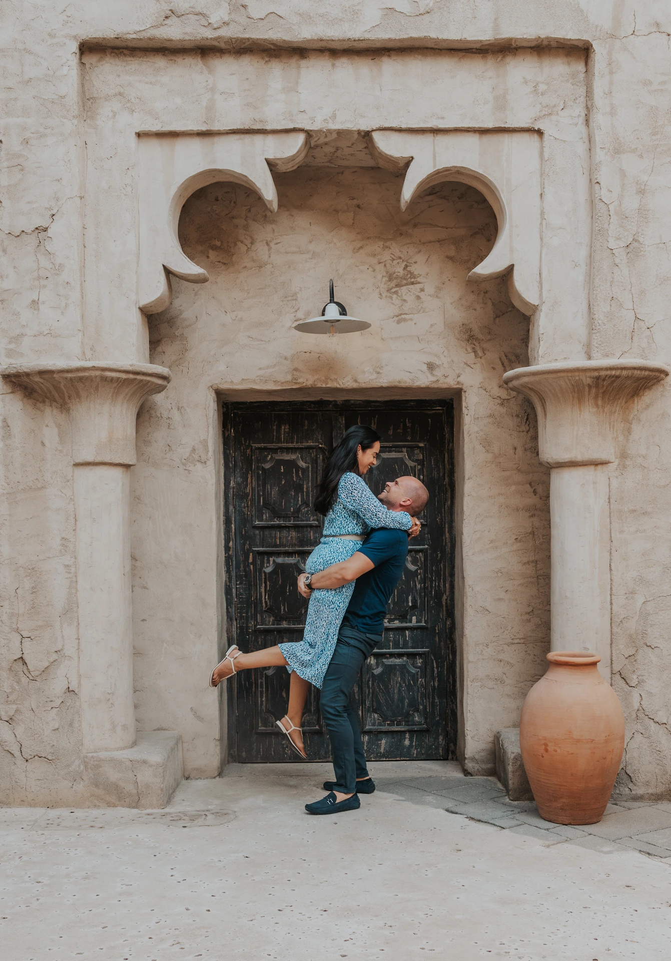 Dubai Couple Photoshoot - Al Seef old-town session A couple is photographed in Al Seef Old Dubai during a couple photoshoot, with heritage textures and narrow lanes adding depth and story.