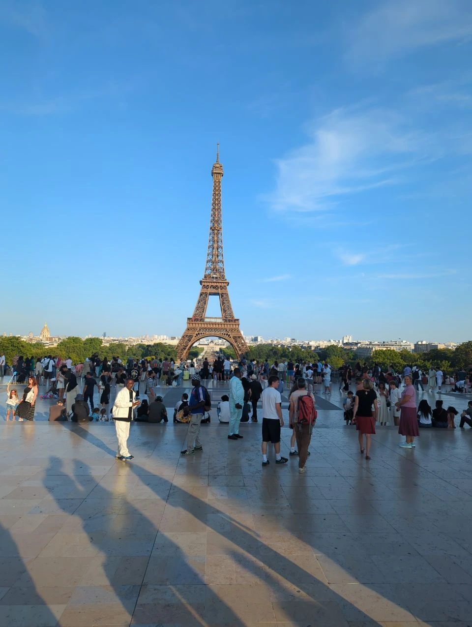 Paris Photo Spots - Trocadero Eiffel View The Eiffel Tower rises beyond the busy Trocadero terrace in Paris, showing an iconic photoshoot backdrop with open city views.