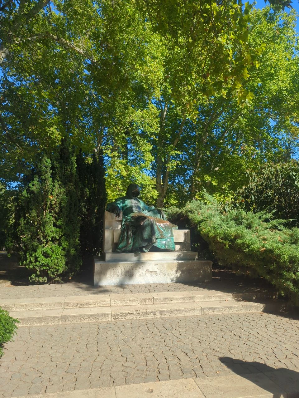 Anonymus statue at Vajdahunyad Castle Hooded Anonymus statue beneath trees at Vajdahunyad Castle