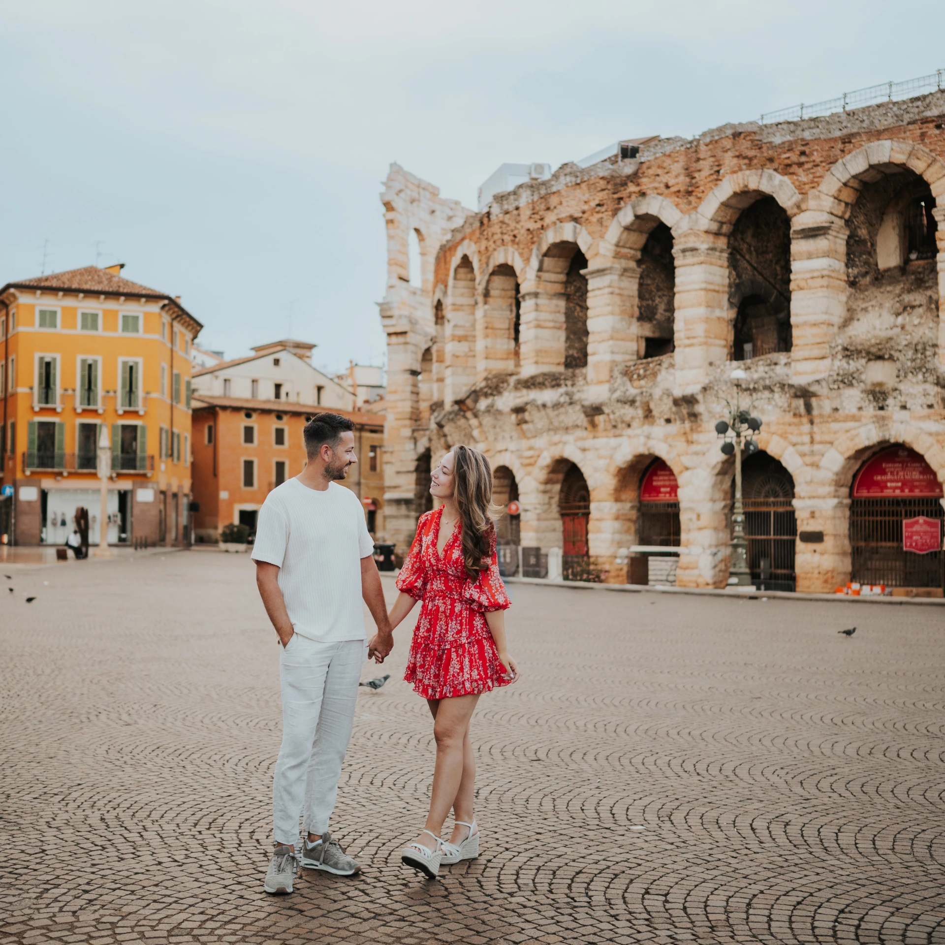 Couple walking in front of the Arena di Verona