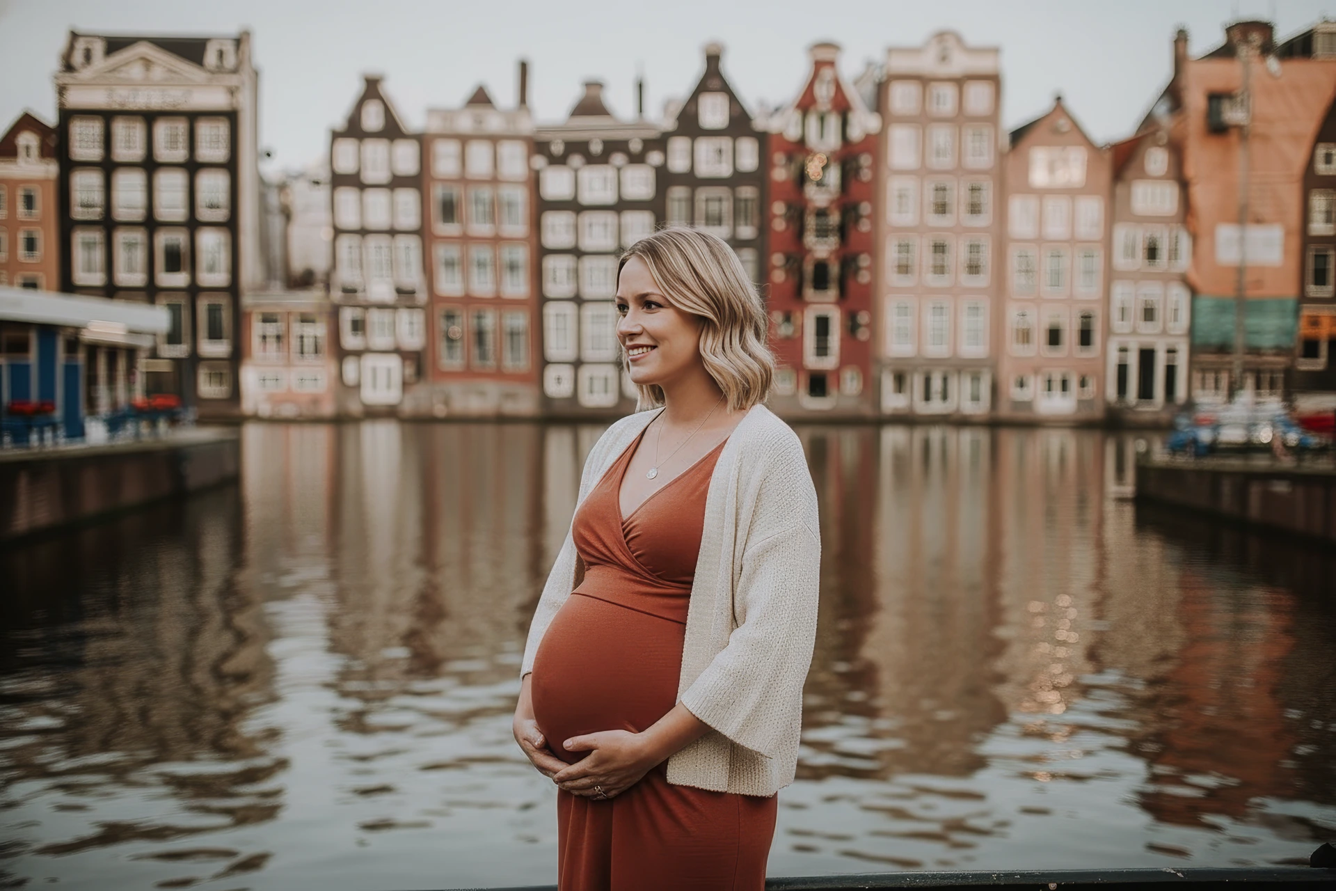 Zwangerschapsshoot van een vrouw in Amsterdam bij de Damrak kade. 